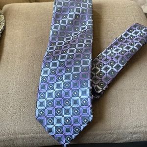 One tie Mayba Alexander Julian or once color is purple squares with silver .